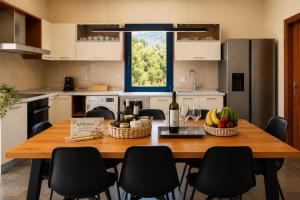 a kitchen with a wooden table with fruit on it at Themis Luxury Private Villa Rhodes with Private Pool in Ialysos
