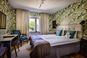 a hotel room with a bed and a desk and a desk at Corner Hotel in Stockholm +154 photos