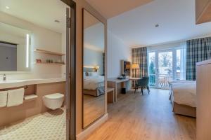 a hotel room with a bed and a bathroom at Seehotel Zarrentin in Zarrentin +44 photos