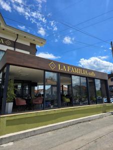 a building with a sign that reads la familia cafe at Vila La Familia in Budžak +10 photos
