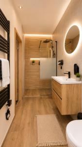 a bathroom with a tub and a sink and a toilet at Aroma Gold in Dolní Bousov +40 photos