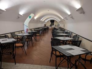a row of tables and chairs in a room at Domus Sessoriana in Rome