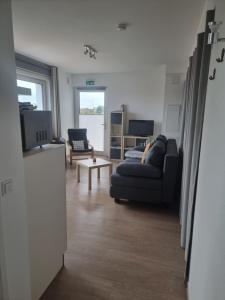 a living room with a couch and a table at Apartment am Apfelgarten in Schwarmstedt