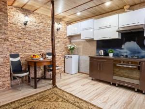 a kitchen with a table and a brick wall at Dostoievski 2 ROOM in Bălţi
