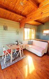 a room with a bed and a table and a couch at Amore in Chianti in Greve in Chianti