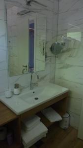 a bathroom with a sink and a mirror at Rooms Gašper 1 in Postojna +15 photos