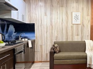 a living room with a couch in a kitchen at Dostoievski 2 ROOM in Bălţi +2 photos