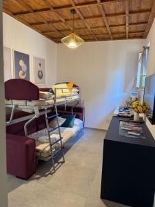 a room with several bunk beds and a table at Casa del Cigno in Monterotondo