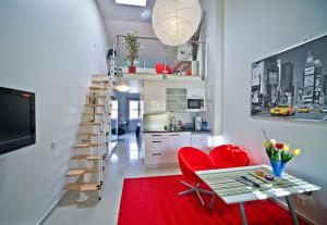 a living room with a red chair and a red rug at Staylong Hotell in Täby