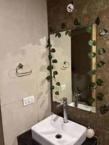a bathroom with a sink and a mirror at Cozy heights in Ghaziabad