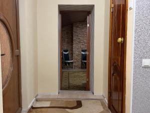 a hallway with a mirror and chairs in a room at Dostoievski 2 ROOM in Bălţi