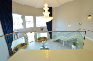 a large room with chairs and a table and a chandelier at Sparrow Boutique Hotel in Bulawayo