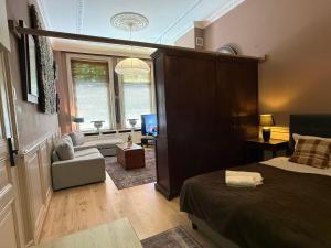 a bedroom with a bed and a living room at Grachtenpracht Boutique in Breda