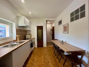 a kitchen with a wooden counter top and a table at L'essentiel Gare d'Oullins - 3 chambres - 15 min de Lyon in Oullins +18 photos