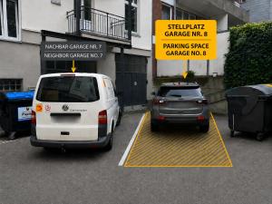 two cars are parked in a parking garage at Apartment am Michel mit Parkplatz in Hamburg
