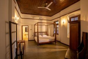 a bedroom with a bed with a wooden ceiling at Ranmin Kings House in Narandanda +27 photos