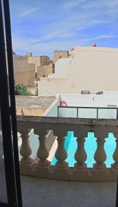 a balcony with a view of a building at GuestElia Gozo in Nadur