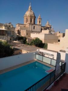 a swimming pool on the roof of a building at GuestElia Gozo in Nadur