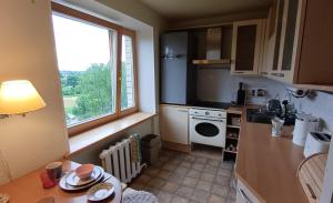a small kitchen with a sink and a window at Light street in Ķekava
