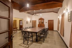 a conference room with a wooden table and chairs at Ranmin Kings House in Narandanda