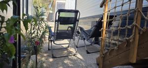a pair of chairs sitting on a porch at Mobile home Bokun sriće in Drage