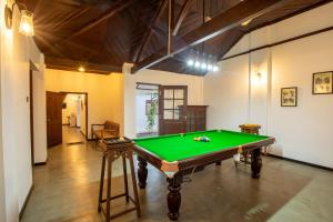 a living room with a pool table in it at Ranmin Kings House in Narandanda