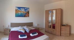 a bedroom with a bed with two pillows on it at GuestElia Gozo in Nadur +49 photos
