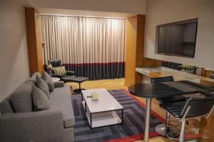 a living room with a couch and a table at Avari Towers Karachi in Karachi