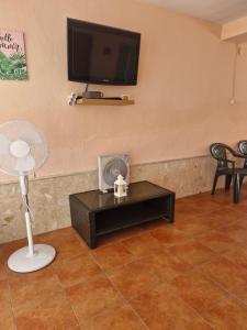 a living room with a tv and a table at Apartamento ILA in Gandía