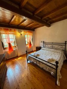 a bedroom with a bed in a room with wooden floors at Hotel Panoramico in Corfino
