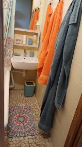 a bathroom with orange towels hanging on the wall at Light street in Ķekava