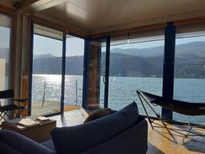 a living room with a view of the water at Botel Diffuso dei Laghi in Porto Ceresio