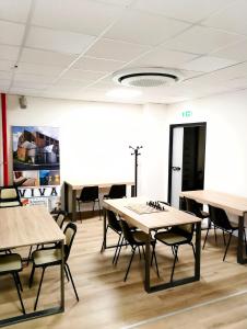 an empty room with tables and chairs in it at Viva Campus di GM Industries srl in Ferrazzano