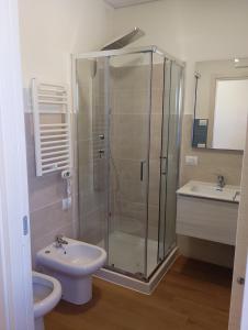 a bathroom with a shower and a toilet and a sink at Viva Campus di GM Industries srl in Ferrazzano