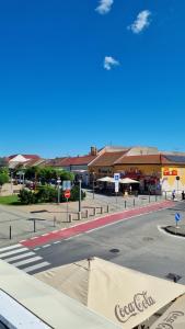 an empty street in front of a shopping center at Elite Pension in Štúrovo +82 photos