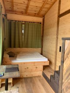 a bed in the inside of a wooden cabin at Garnecker Freiheit in Reut