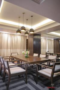 a conference room with a large wooden table and chairs at Avari Towers Karachi in Karachi