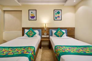 a room with two beds in a room at Treebo Premium PL Grand, Visakhapatnam in Visakhapatnam +47 photos