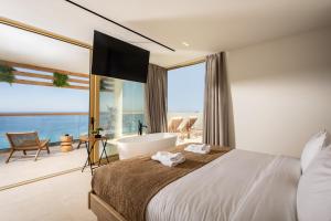 a bedroom with a bed and a bath tub and a view at Callisto Azzure in Zakynthos +72 photos