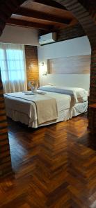 a bedroom with a large bed in a room at Hotel Domus Auditorium Suites in Villa Carlos Paz
