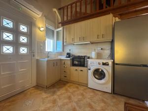 a kitchen with a refrigerator and a washing machine at Mersea standard apartment Kourouta in Kourouta