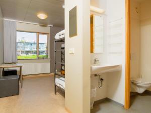 a bathroom with a sink and a toilet at Dalur - HI Eco Hostel in Reykjavík