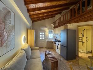 a living room with a couch and a refrigerator at Mersea standard apartment Kourouta in Kourouta +17 photos