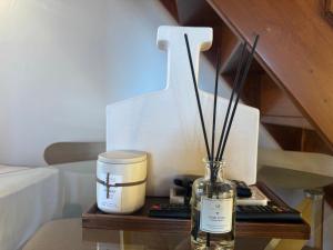 a table with a bottle of wine and a candle at Mersea standard apartment Kourouta in Kourouta