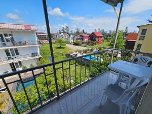 a balcony with a table and a view of a city at Imeri Hotel in Ureki