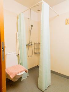 a bathroom with a shower and a toilet at Dalur - HI Eco Hostel in Reykjavík