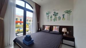 a bedroom with a bed and a large window at ADRi in Phú Quốc +66 photos