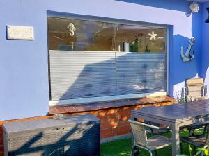 a table and a window with a table and chairs at Bungalow Koje in Kröslin
