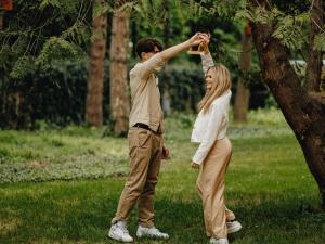 a man and a woman standing next to a tree at Ibis Budapest Citysouth in Budapest