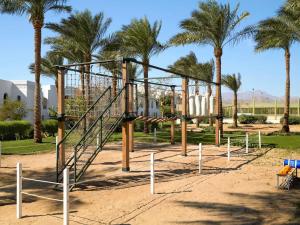 a playground in a park with palm trees at Hotel Novotel Sharm El-Sheikh in Sharm El Sheikh